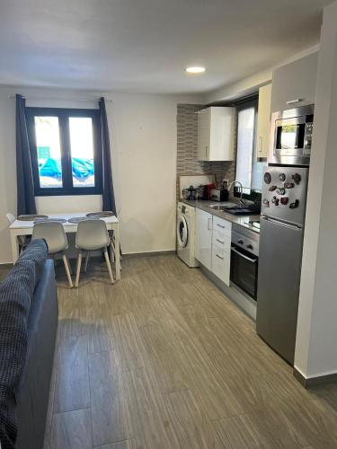 a kitchen with a couch and a table in a room at luxury casa playa roca bord de mer in Costa Teguise