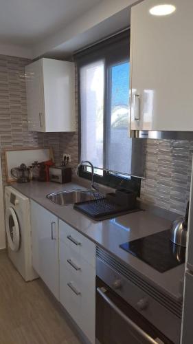 a kitchen with a sink and a dishwasher at luxury casa playa roca bord de mer in Costa Teguise