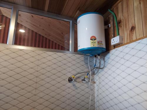 a bathroom with a water tank and a counter top at Athithi homestay in Darjeeling