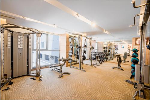a gym with a row of treadmills and machines at Libra Hotel Nha Trang in Nha Trang