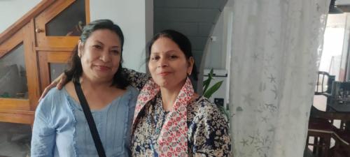 two women are standing next to each other at Newa House Homestay in Siliguri