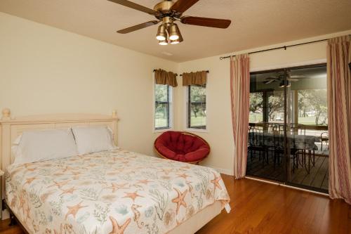 a bedroom with a bed and a ceiling fan at 9th Tee in Caswell Beach