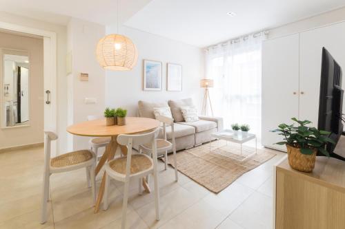 a living room with a table and a couch at Beach & Port in Gand&iacute;a