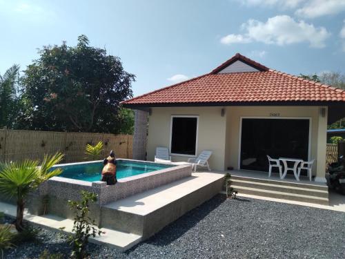 a house with a swimming pool in the backyard at Villa MILTONIA in Ban Ai Dao