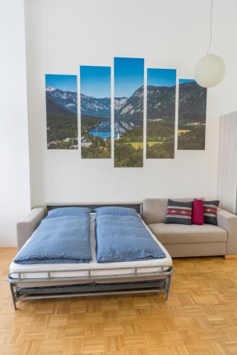 a bedroom with a bed and a couch at DREAM & RELAX Apartment in Bohinj