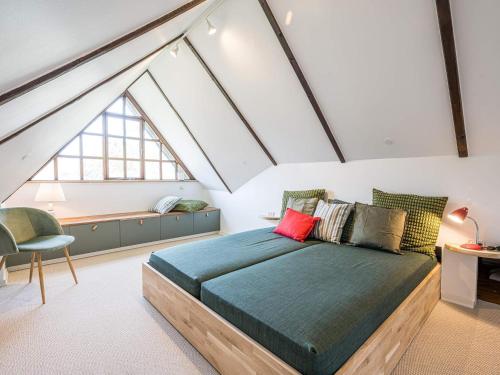 a bedroom with a large bed in a attic at Holiday home Nørre Nebel LVII in Nørre Nebel