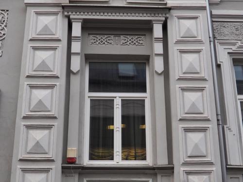 a building with a window with white trim at Vilnius street apartment in Vilnius