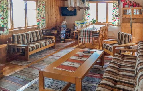 a living room with wooden furniture and a table at 2 Bedroom Lovely Home In Sörsjön in Sörsjön
