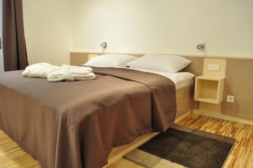 a bedroom with two beds with white pillows at Apartments City&style in Zagreb
