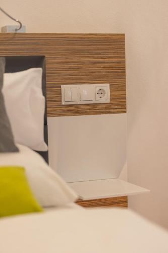 a bedroom with a bed with a clock on the wall at Boardinghouse HOME - adults only - in Konstanz