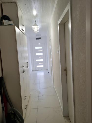 a hallway with a white floor and a white door at Villa Agata in Lastovo