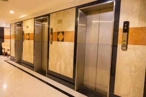 a row of elevator doors in a building at Three 888 Hotel in Dubai