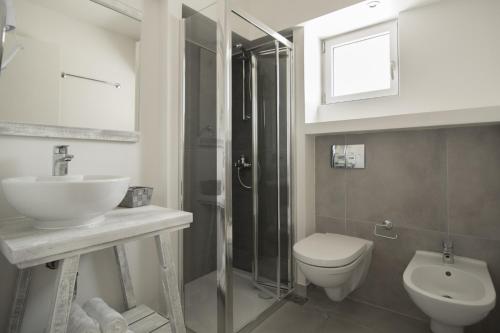 a bathroom with a toilet and a sink and a shower at Vourkari Village in Vourkarion