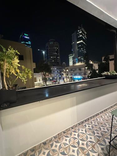 a view of a city at night from a building at De Pejoto in Tel Aviv