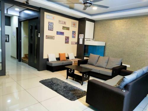 a living room with a couch and a table at 678 homestay 4 room 5 minutes to tower in Teluk Intan