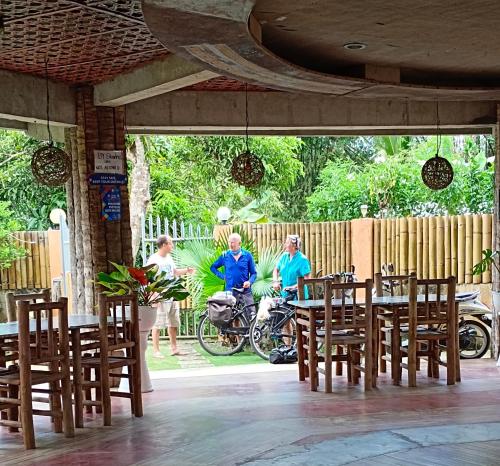 a group of people sitting at a table in a restaurant at Greenhut Pension & Bar in Jagna