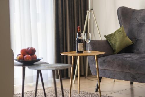 a bottle of wine on a table next to a couch at Boardinghouse HOME - adults only - in Konstanz