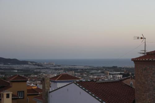 a view of the ocean from the roofs of buildings at Villa Granada Motril in Motril