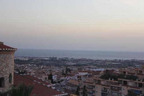 a view of a city with the ocean in the background at Villa Granada Motril in Motril