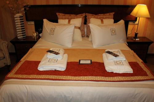 a bedroom with a bed with towels on it at Villa Granada Motril in Motril