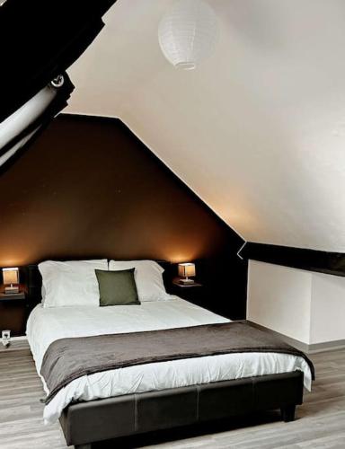 a bedroom with a large bed with a black headboard at Cosy Dunkerquois in Dunkerque
