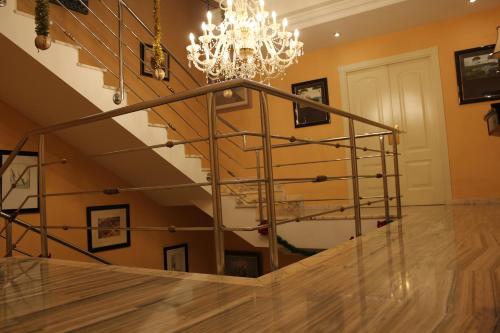a staircase with a chandelier in a house at Villa Granada Motril in Motril