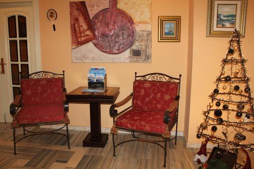 a living room with two chairs and a christmas tree at Villa Granada Motril in Motril