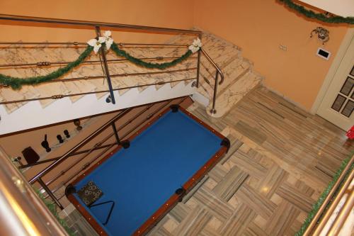 a pool table in a living room next to a staircase at Villa Granada Motril in Motril