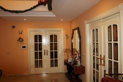 a living room with orange walls and white doors at Villa Granada Motril in Motril