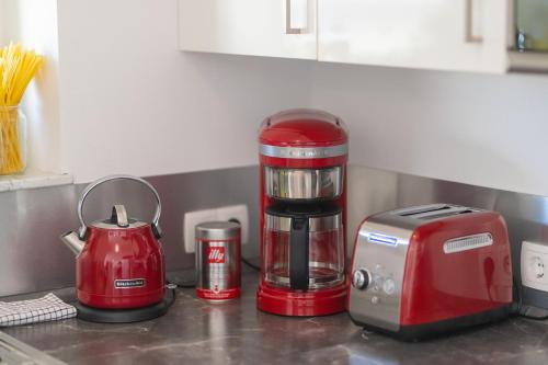 a red coffee maker sitting on a kitchen counter at Boardinghouse HOME - adults only - in Konstanz