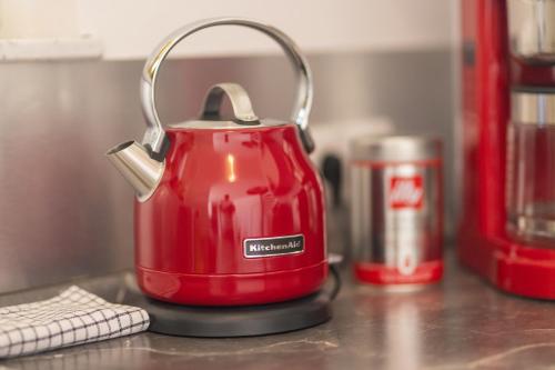 a red tea kettle sitting on a kitchen counter at Boardinghouse HOME - adults only - in Konstanz