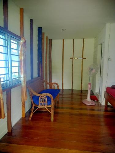 a living room with a blue couch and a window at Bunnan Bungalows in Koh Rong Island