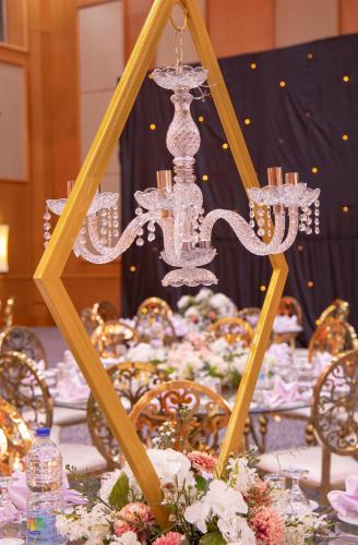 a table with a chandelier on top of it at Tolip Olympic International City in New cairo