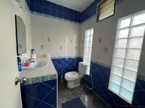 a blue and white bathroom with a toilet and a sink at Dragon Dream 1 D6 Hua Hin with Pool in Cha Am