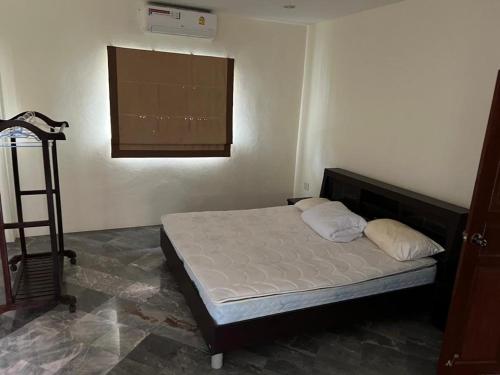a bedroom with a bed in a room with a window at Dragon Dream 1 D6 Hua Hin with Pool in Cha Am