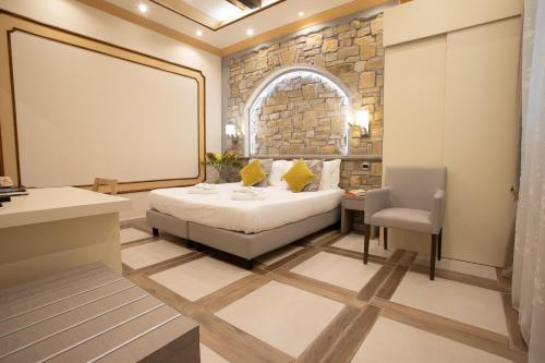 a bedroom with a bed and a stone wall at Antica Piacenza in Piacenza