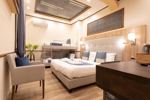 a bedroom with a bed and a desk with a chair at Antica Piacenza in Piacenza