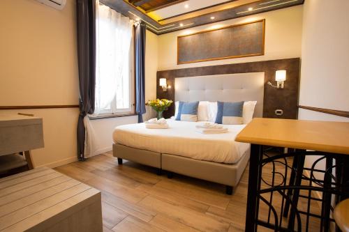 a bedroom with a bed and a table with flowers on it at Antica Piacenza in Piacenza