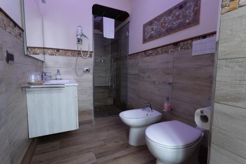 a bathroom with a toilet and a sink and a shower at Antica Piacenza in Piacenza