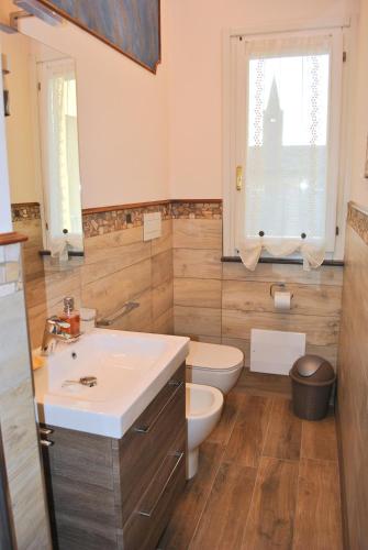 a bathroom with a sink and a toilet at Antica Piacenza in Piacenza