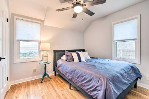 een slaapkamer met een bed en 2 ramen bij Pet-Friendly Uptown Normal Home Steps to ISU in Normal