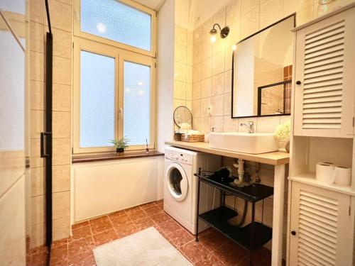 a bathroom with a washing machine and a sink at Elegant apartment in Kosice in Košice