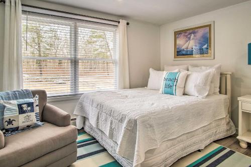 a bedroom with a bed and a chair and a window at Cozy Edgartown Vacation Rental Near Beach! in Edgartown