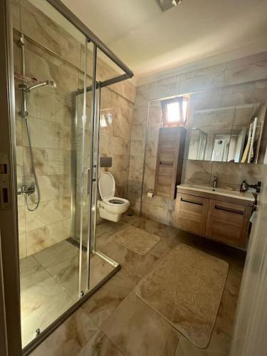 a bathroom with a shower and a toilet and a sink at 10 minutes to Trabzon city Full view special villa in Kisarna