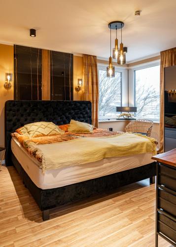 a bedroom with a large bed and a window at Fewo Elegance in Binz