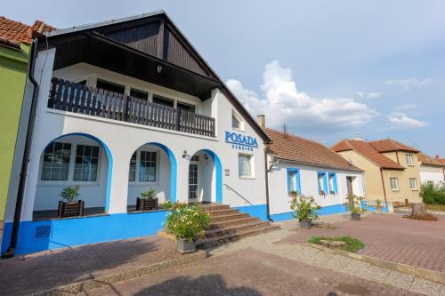 a white and blue building with a balcony at Penzion POSADA in Podivín