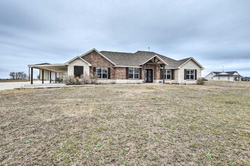 a house with a large field in front of it at Secluded Krum Home with Patio and Gas Grill! in Krum