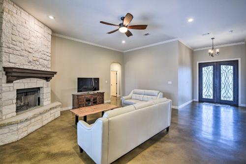 a living room with a couch and a fireplace at Secluded Krum Home with Patio and Gas Grill! in Krum