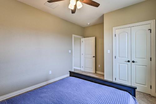 a bedroom with a ceiling fan and a blue rug at Secluded Krum Home with Patio and Gas Grill! in Krum
