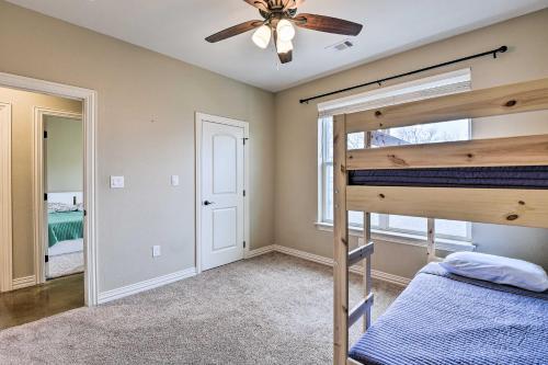 a bedroom with a bunk bed and a ceiling fan at Secluded Krum Home with Patio and Gas Grill! in Krum